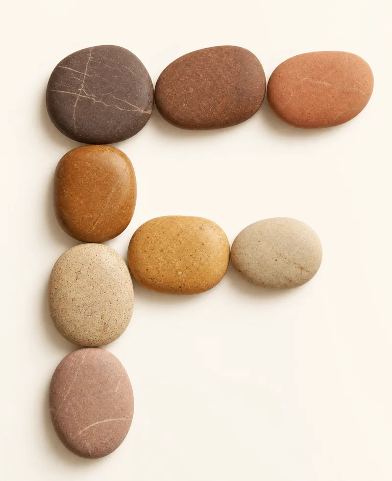 Natural stones in the Froscale palette arranged as the letter F
