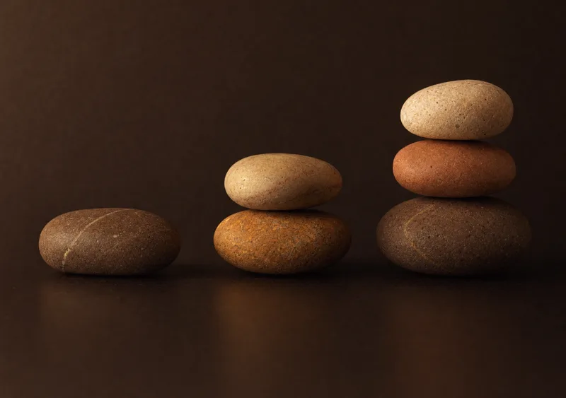 Three stone stacks rising in height — one, two, three stones